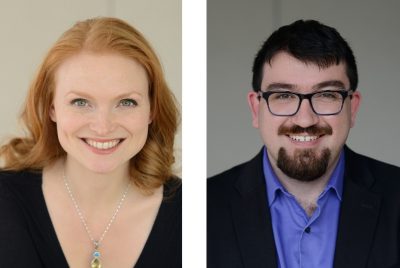 Head shots of a woman with red hear in a black top wtih a necklace and a man wearing a blue shirt, dark jacket, dark hair and glasses.