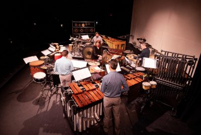 Members of the Sympatico Percussion Group stand amoung various percussion instruments