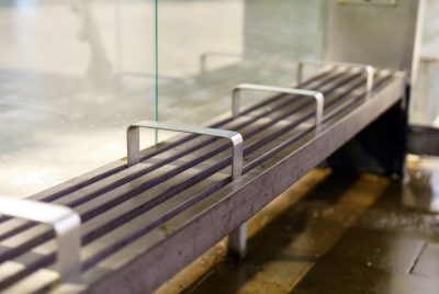 image of a grey metal bench with bars preventing someone from lying down  Credit: Abode stock images