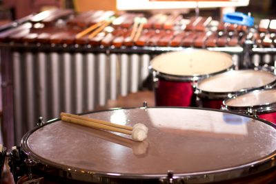 A timpani drum and mallet, snare and tom drums, marimba and mallets