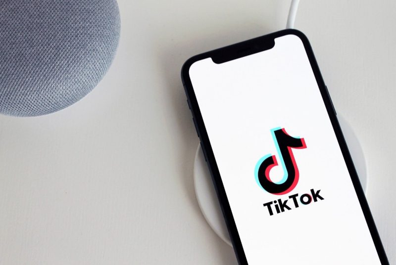 A smart phone with the TikTok logo on the screen and the words TikTok