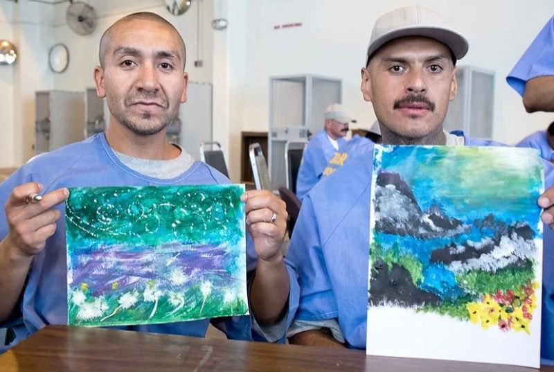 Two members of the Prison Arts Collective show their artwork