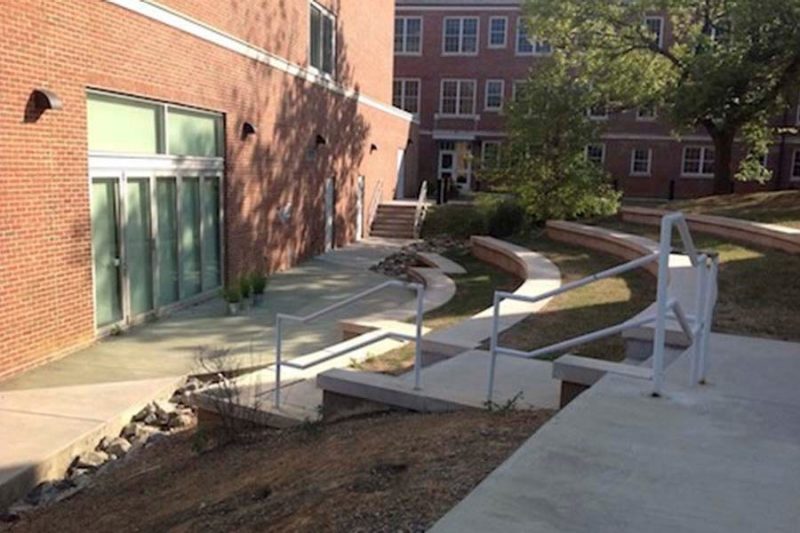 Small outdoor amphitheatre that faces the outer brick wall of an academic building on campus.