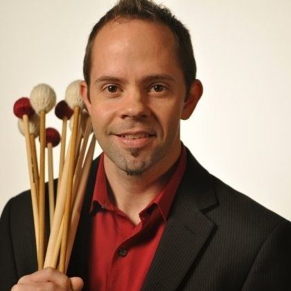 Percussionist Jay Ware holds a fistful of mallets over his shoulder